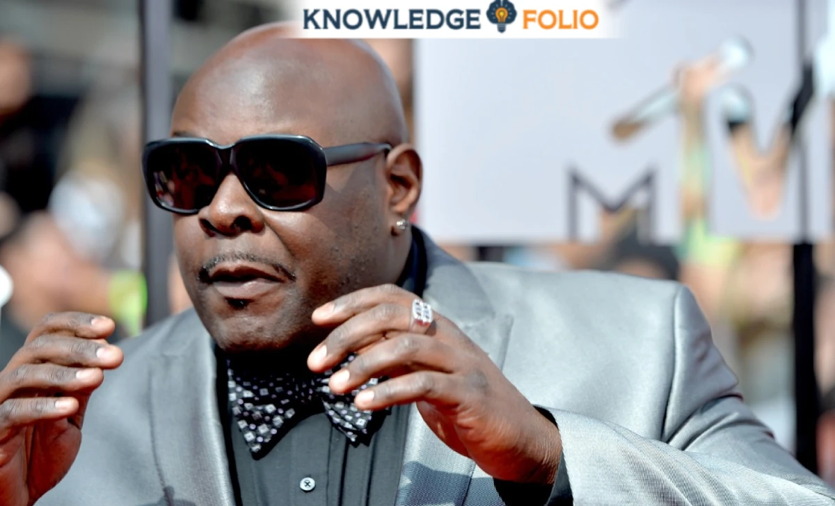 Christopher Boykin sitting at a desk with family photos and financial papers, symbolizing his careful planning for his daughter Isis’s future.