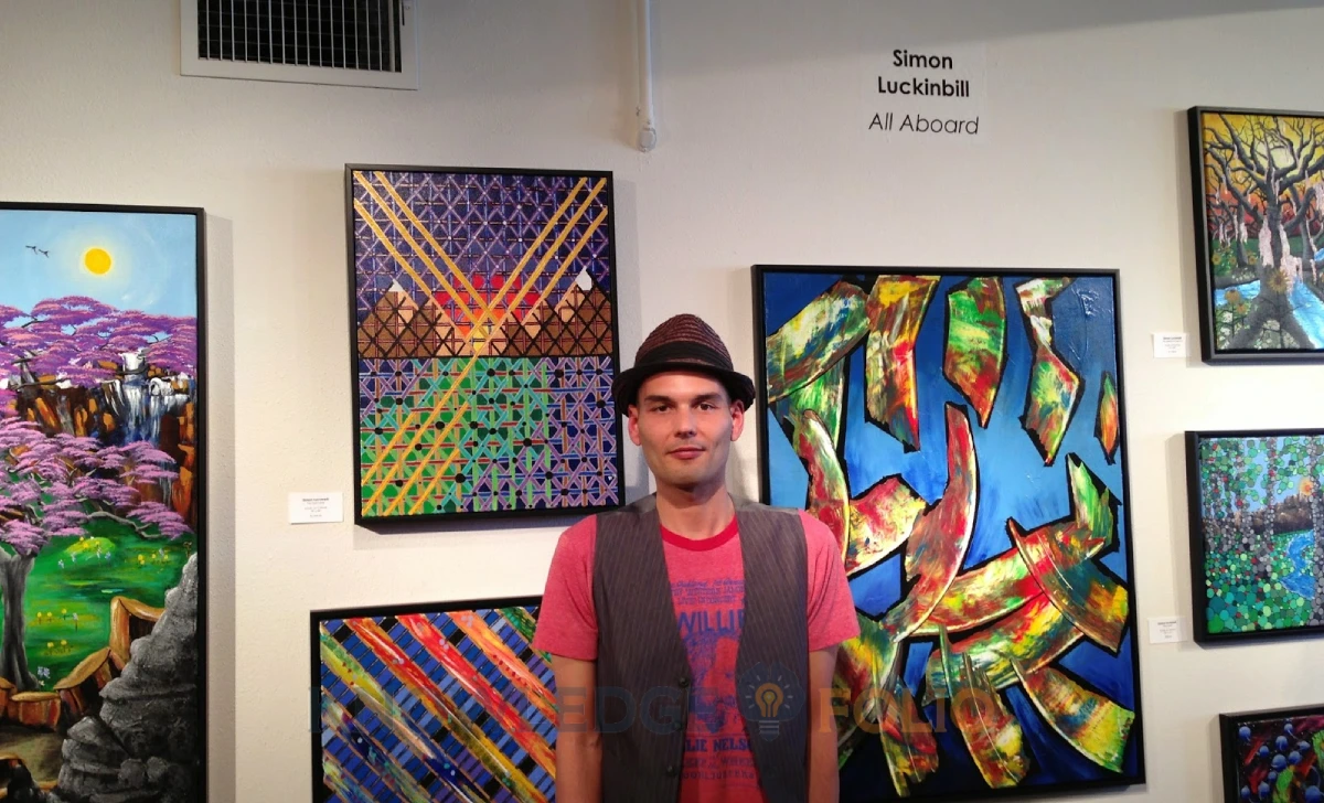 Simon Luckinbill painting an acrylic artwork in his studio.